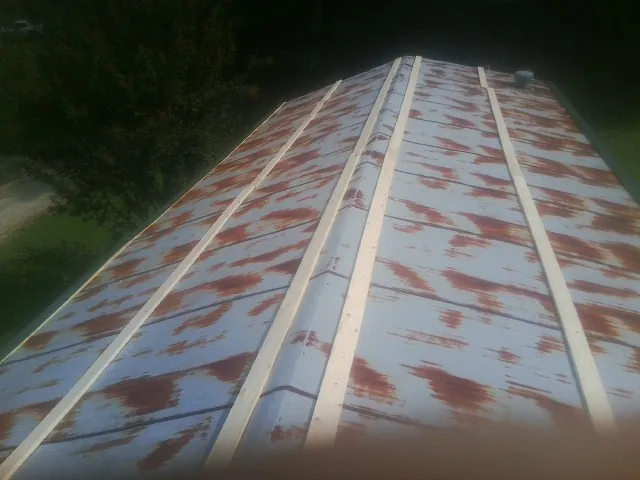 Rusted metal roof panels with new wood purlins before replacement — Storm Damage Roof Repair in Pembroke by Roofing Brothers